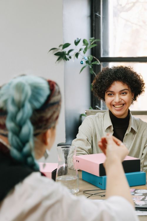 Colleagues talking together at a work table